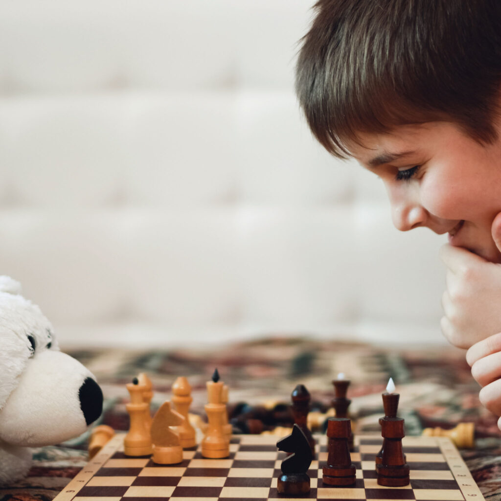 SchoolChessAssociation-SummerFunMN_Images_21_0000_NewBoyPlayingChess